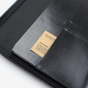 Open black A4 leather compendium with internal pockets